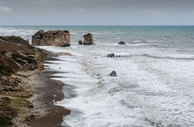 Seascape with windy waves during storm weather at the rocky coastal area in paphos cyprus.