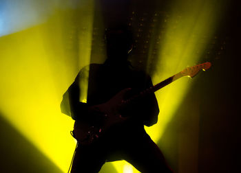 Low angle view of silhouette guitarist