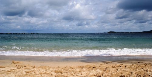 Scenic view of sea against cloudy sky