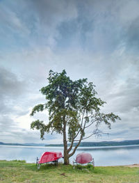 Simple rowing boat stacked at lake upside down. empty beach at popular tourist resort.