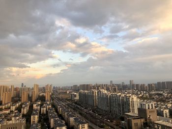 High angle view of city against cloudy sky