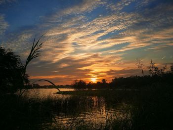 Scenic view of lake against sky during sunset