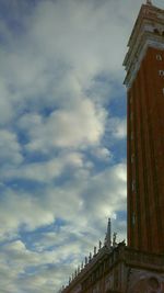 Low angle view of tower against cloudy sky