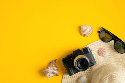 High angle view of yellow camera on table