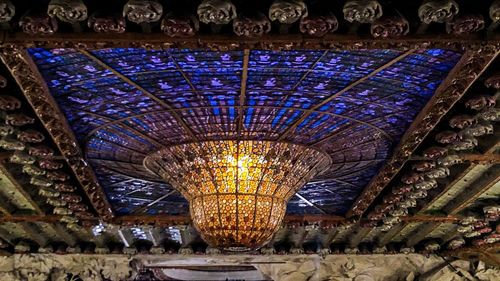 Low angle view of illuminated lights hanging in ceiling