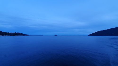 Scenic view of sea against blue sky