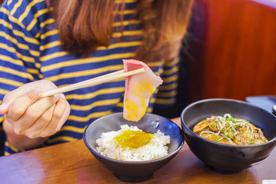 Midsection of woman eating food