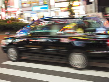 Blurred motion of car on illuminated city