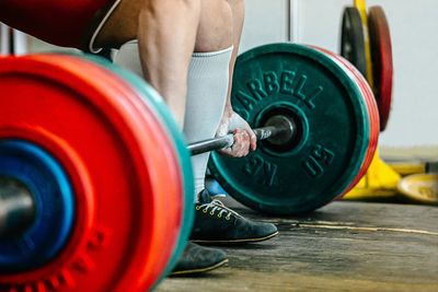 Cropped hand of man exercising in gym