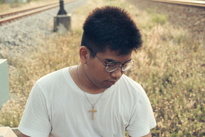 Close-up of thoughtful young man sitting outdoors