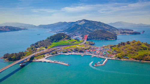 High angle view of sea and mountains against sky