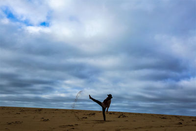 Man standing on beach against sky