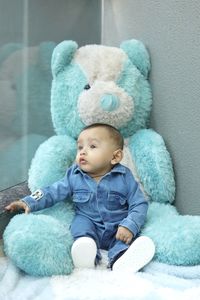 Cute baby boy sitting on toy