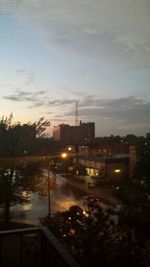 View of illuminated buildings at sunset