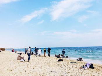 People on beach against sky