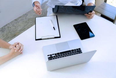 High angle view of woman using laptop on table