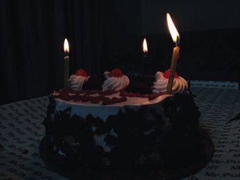 Lit candles on cake