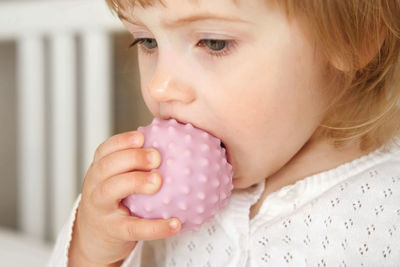 Baby girl playing tactile knobby balls. young child hand plays sensory massage ball