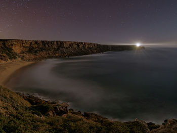 Scenic view of land against sky at night