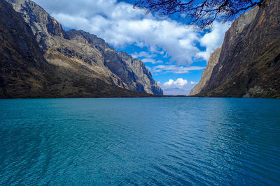 Scenic view of sea and mountains against sky