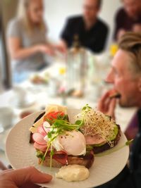 People holding food in restaurant