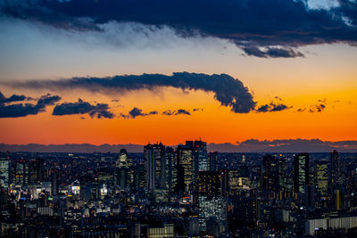 High angle view of modern buildings against sky during sunset