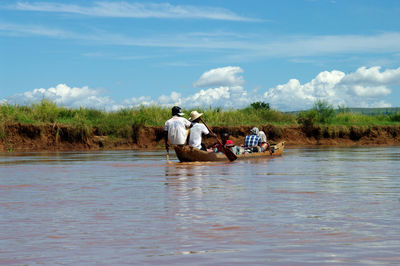 People working in river against sky