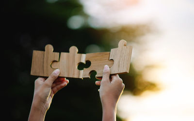 Cropped hand of person holding toy blocks