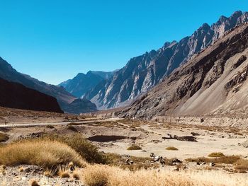 Scenic view of snowcapped mountains against clear blue sky
