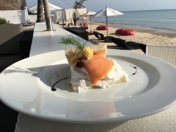 Close-up of food served on beach