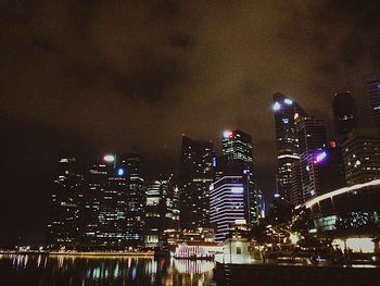 Low angle view of illuminated cityscape against sky at night