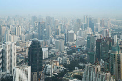 High angle view of modern buildings in city against sky