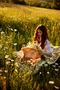 Young woman sitting on field