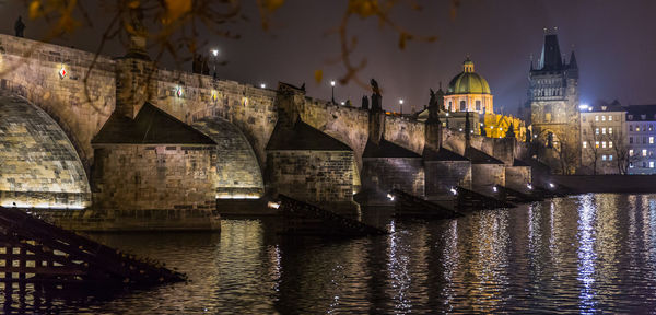 View of bridge over river at night