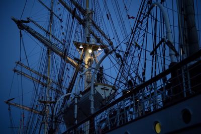 Low angle view of sailing ship against sky at twilight