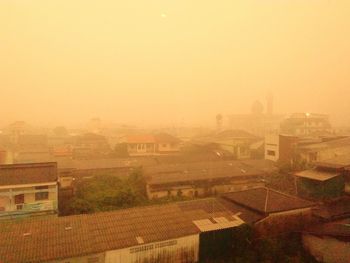 High angle view of buildings against sky during sunset