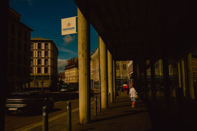 Rear view of man walking in city at night