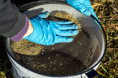 High angle view of hand separating food in container 