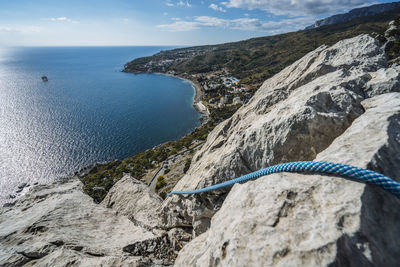 Climbing rope on top mountain with the view over village of katsiveli. crimea