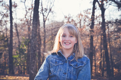 Portrait of smiling boy against trees