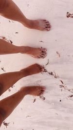 Low section of person on sand at beach