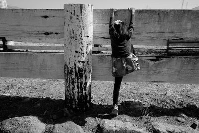 Rear view of woman standing on beach