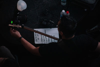 Rear view of man playing piano