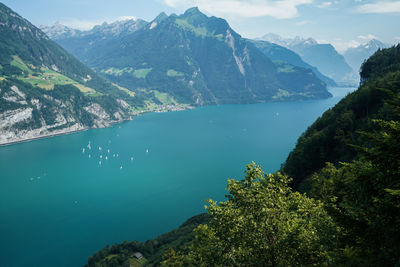 Scenic view of sea and mountains against sky