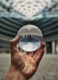 Close-up of man hand holding crystal ball