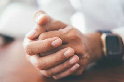 Close-up of man holding hands