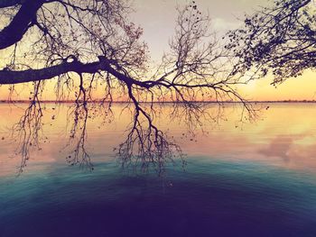 Scenic view of lake against sky at sunset