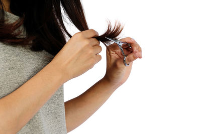 Close-up of woman hand against white background