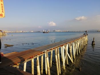 Pier over sea against sky