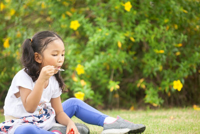 Cute girl sitting on plant